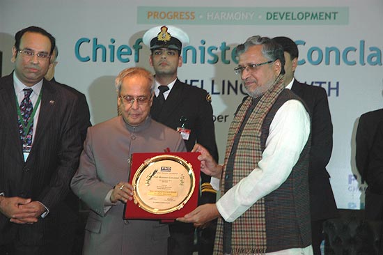 Bihar Deputy Chief Minister, Sushil Kr. Modi being awarded with a trophy for highest Industrial growth, by President Pranab Mukherjee, at The Chief Minister's Conclave & 107 Annual Session" of The PHD Chambers of Commerce & Industry held at Hotel Le-Meridiaen, New Delhi on 15 Dec. 2012.