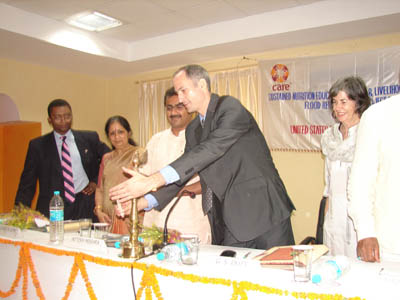 Mr Moulik D Berkana, Deputy Director, American Center, Kolkata, lighting the lamp at the formal ceremony to announce presentation of $3 million by USDA to CARE for the states of Bihar, West Bengal, Orissa, and Uttar Pradesh as part of disaster relief efforts in India.